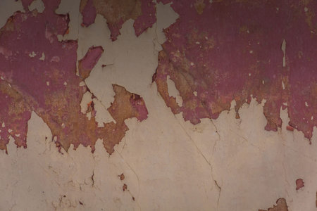 Grunge dirty wall close up, red cracked plaster background.