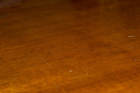 Lacquered wooden table surface close up background.