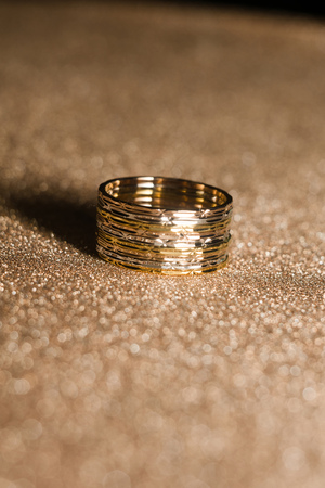 Fashion golden ring over glittering background, macro.の写真素材
