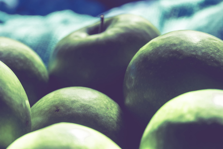 Pile of ripe green apples close up vintage background.の写真素材