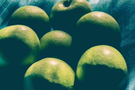 Pile of ripe green apples close up vintage background.の写真素材