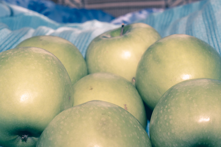 Pile of ripe green apples close up vintage background.の写真素材