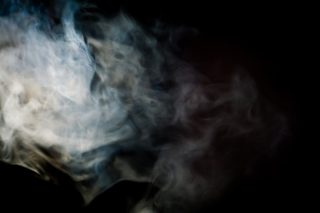 Hot streaming steam in the dark room background.の写真素材