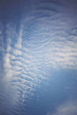 Peaceful blue sky with white clouds landscape filtered.の写真素材
