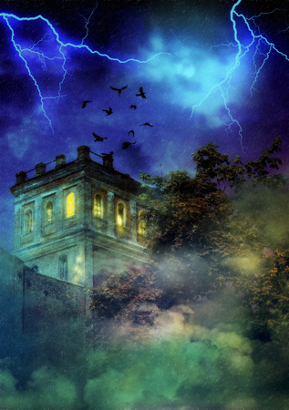 Abandoned old spooky castle during storm in the night.の写真素材
