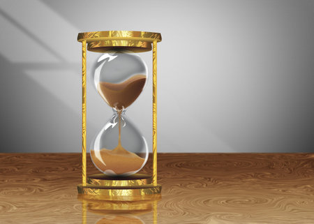 Decorative vintage style hourglass on a wooden table background.