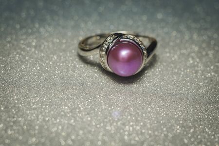 Luxury silver ring with natural freshwater pearl of purple color, macro.の写真素材