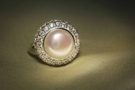 Luxury silver ring decorated with freshwater pearl of white color and diamonds.の写真素材