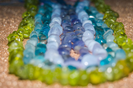 Natural stone small beads of tanzanite, agate, aquamarine, apatite and peridot close up.の写真素材