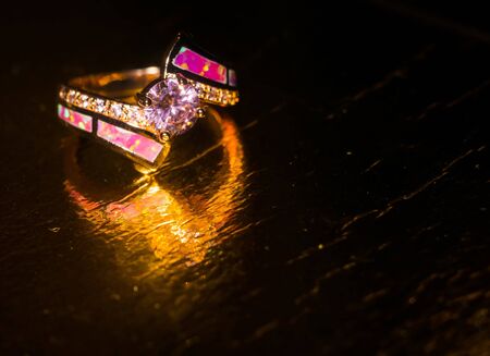 Fashion rose gold ring with pink zircon and synthetic opal stone.の写真素材