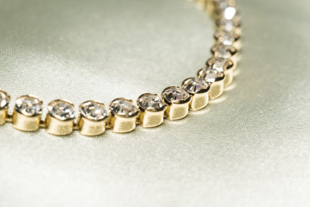 Yellow gold bracelet with white zirconia background.