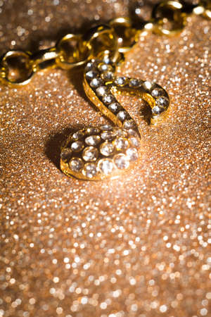 Fashion bracelet with decorative gold charms in a shape of a music note background.の写真素材