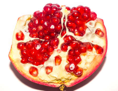 Part of fresh ripe pomegranate with seeds on white background.の写真素材