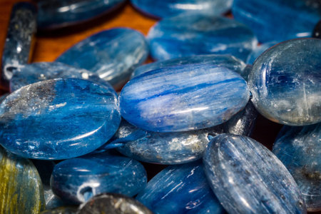 Natural blue kyanite stone, oval shape beads background.