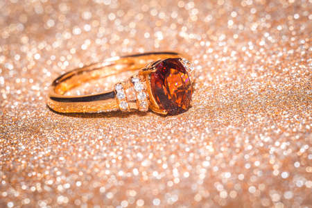 Fashion golden ring with a dark red garnet stone.の写真素材