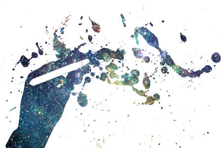 Human hand holding paintbrush and abstract starry space design.の写真素材