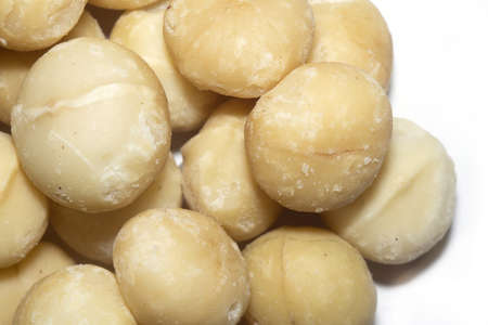 Peeled fresh macadamia nuts close up background.の写真素材