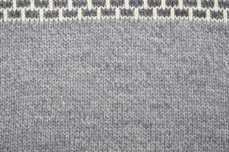 Close up photo of gray wool sweater texture as abstract background.