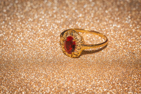 Yellow gold ring decorated with red quartz stone.の写真素材