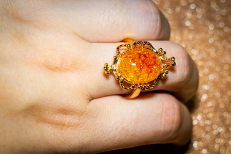 Fashion golden ring with big yellow amber, fake stone.の写真素材