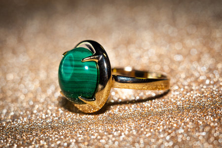 Fashion golden ring with big green malachite, natural stone.の写真素材