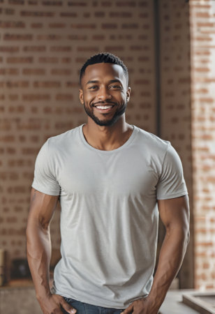 Young, handsome dark skinned man smiling at the viewer, modern hairstyle, gray melange t shirt.の素材