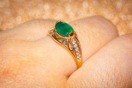 Fashion golden ring with green agate, close up background.の写真素材