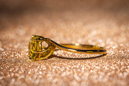 Fashion golden ring with yellow stone, close up background.の写真素材