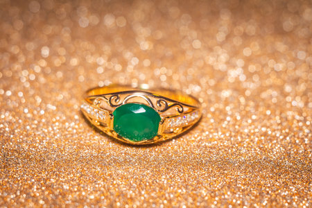 Fashion golden ring with green agate, close up background.の写真素材