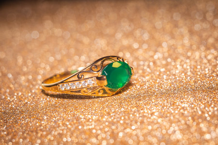 Fashion golden ring with green agate, close up background.の写真素材