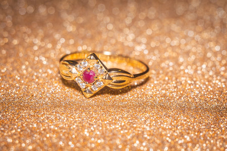 Fashion golden ring with ruby, close up background.の写真素材
