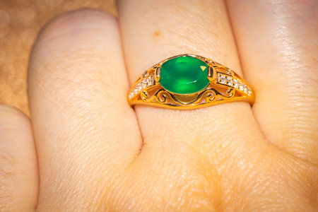 Fashion golden ring with green agate, close up background.の写真素材