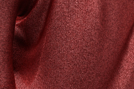 Detailed shiny red fabric background. Beautiful soft wavy folds on smooth shiny piece of cloth. Background for anniversary, Christmas, wedding, birthday, Valentine's Day, events concept. 3D Illustration.の写真素材