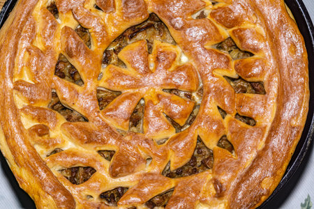 Decorative meat pie with a tasty crust with hearty minced beef cooked with vegetables. Homemade...
