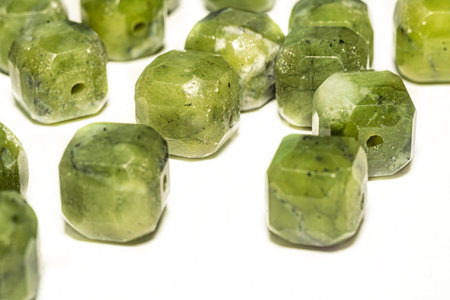 Beautiful green jade beads in macro photography, perfect for crafting and jewelry design. Decorative...