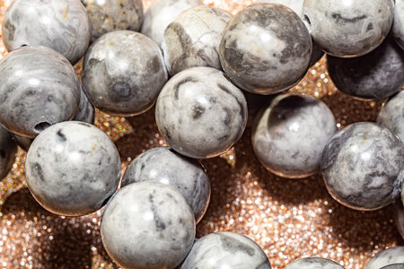 Beautiful round beads of gray jasper in macro photography, perfect for crafting and jewelry design. Decorative round stone beads of gray color for boho jewelry design.の写真素材