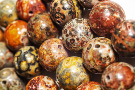 Macro photo of round leopard jasper beads. Perfect for jewelry design, crafting, and nature-themed projects. Capture the intricate beauty of leopard jasper beads for your creative needs.の写真素材