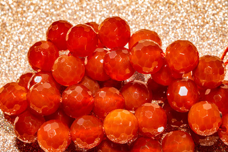 Beautiful red carnelian beads in macro photography, perfect for crafting and jewelry design. Decorative faceted carnelian stone beads for boho jewelry.の写真素材