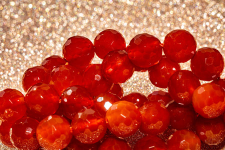 Beautiful red carnelian beads in macro photography, perfect for crafting and jewelry design. Decorative faceted carnelian stone beads for boho jewelry.の写真素材