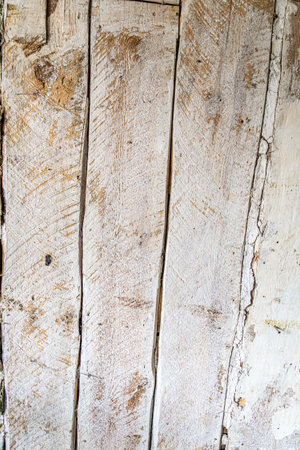 Detailed close up of rustic wooden planks with natural grain, rough texture, scratches, and weathered surface. Perfect background for design projects, vintage decor, carpentry, and creative artwork.の写真素材