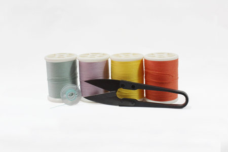 Thread for sewing. Scissors and bobbin for sewing machine.