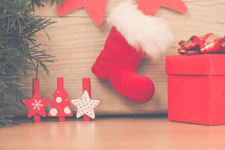 Christmas arrangement with red boot gift and wooden stars and fir treeの写真素材