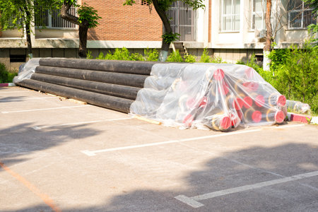 Pile of black pipes wrapped in plastic