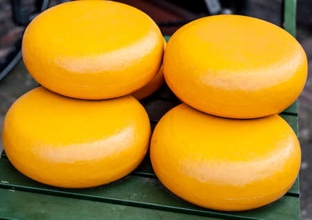 Dutch Gouda cheese wheels in a cheese markeの写真素材
