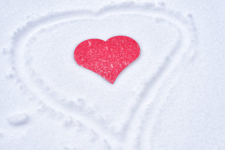 Red paper heart in the fresh snow