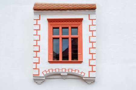 Rustic red window on white wall in Sighisoara Romaniaの写真素材