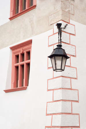Old street lamp hanging on the wall of a houseの写真素材