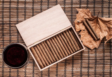 Cigarillos, wine and an old leaf still life