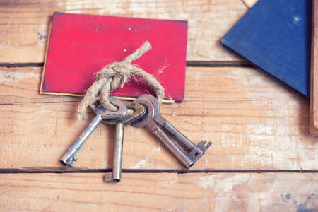 Old keys and documents on wooden backgroundの写真素材