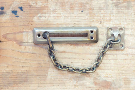 Vintage door locker with chain on wooden backgroundの写真素材
